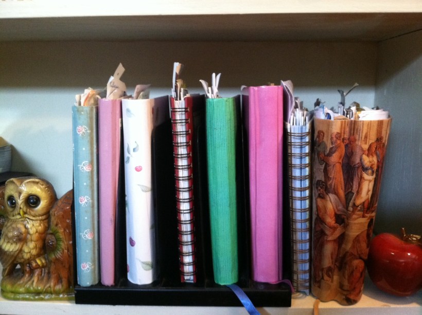 My stack of journals minus the fatter one on my nightstand