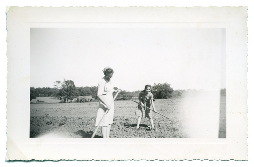 Aunt Ruthie with scarf and I hoeing in tomato field