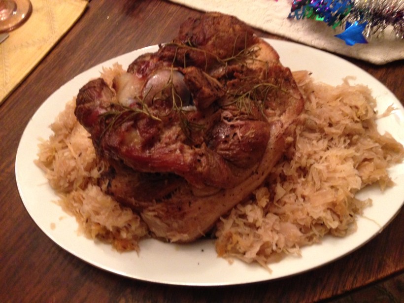 Pork basted with mixture of meat juices, minced garlic, fresh dill, onion salt and dry mustard Sauerkraut with caraway seeds; baked apples