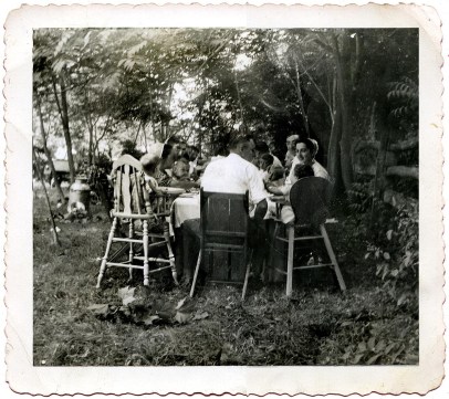 I'm sitting in high chair to the right at Metzler reunion picnic 