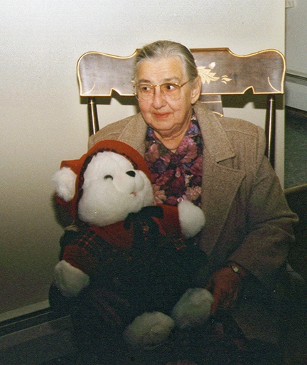 Mom with sheepish look holding teddy bear 1992